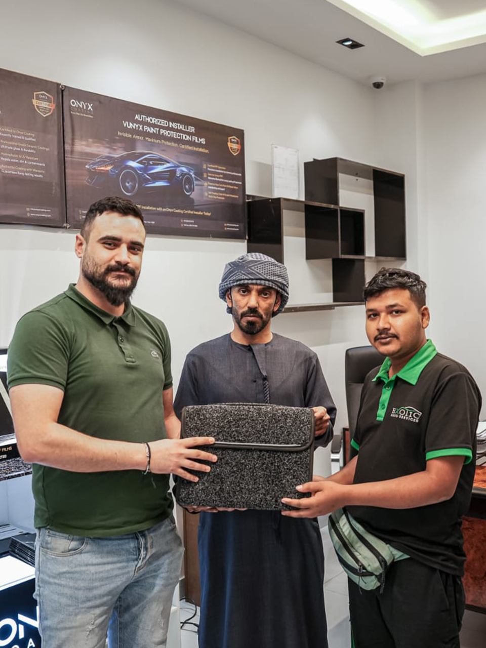 Al‑Rabiya sales representative presenting a reward to a car care partner for outstanding performance