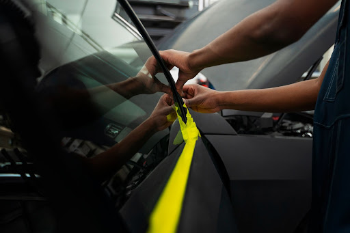 person applying Luminous Window Film to a car window